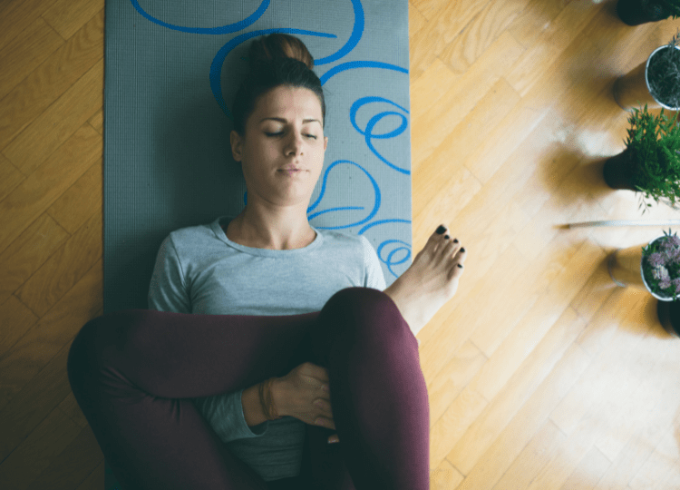 Woman practicing yoga lying in Reclined Butterfly exercise Stock Photo by  ©Koldunov 278559676